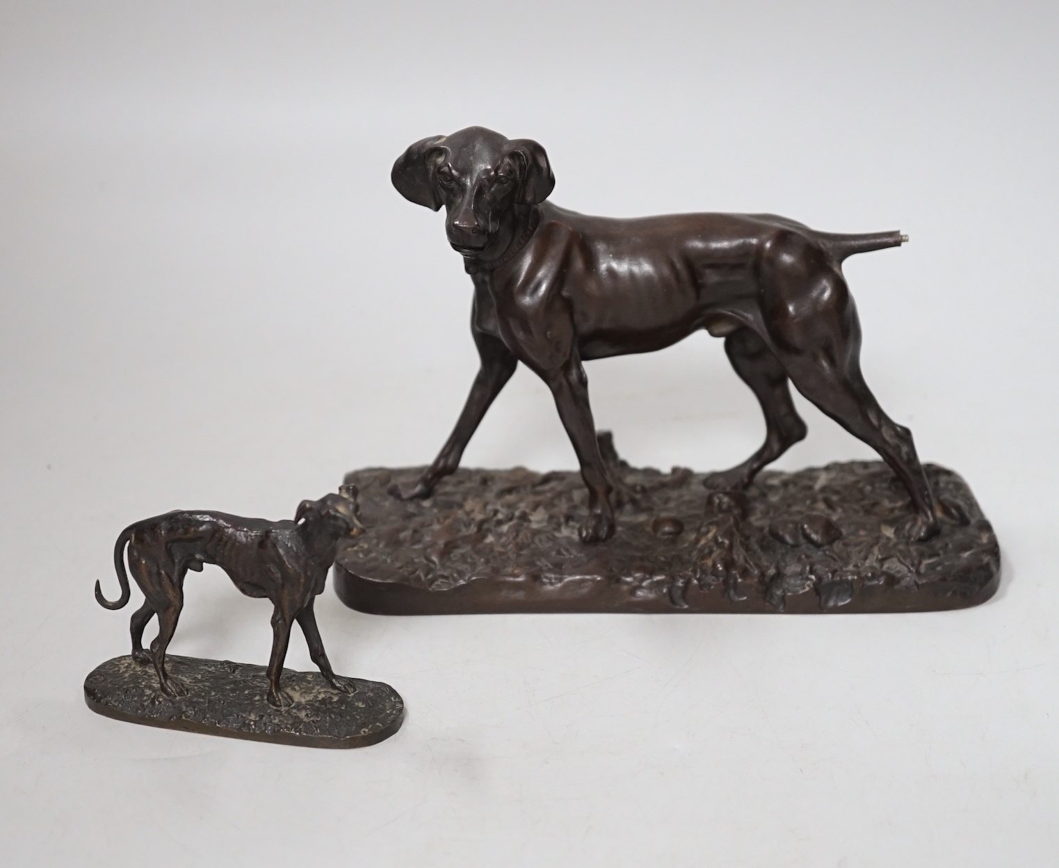 After Pierre-Jules Mêne (1810 – 1879) a patinated cast iron hound and a similar small bronze figure of a greyhound, the largest 18cm wide